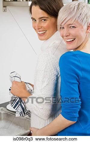 A lesbian couple washing up View Large Photo Image Stock Image - A lesbian couple washing up. Fotosearch