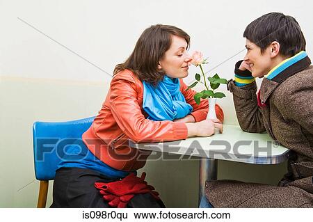 A woman smelling a flower View Large Photo Image Stock Photograph - A woman smelling a flower. Fotosearch