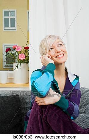 A woman using a cell phone View Large Photo Image Stock Image - A woman using a cell phone. Fotosearch