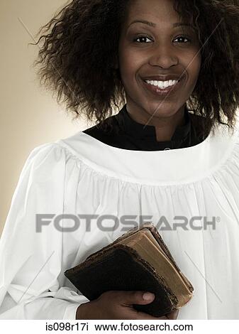 A gospel singer holding a bible View Large Photo Image Stock Image - A gospel singer holding a bible. Fotosearch