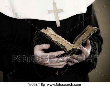 A nun holding a bible View Large Photo Image Stock Photography - A nun holding a bible. Fotosearch