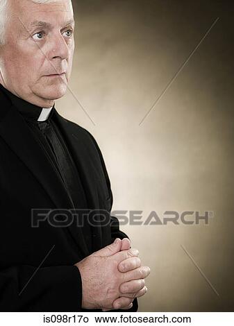 Picture - A priest praying. Fotosearch