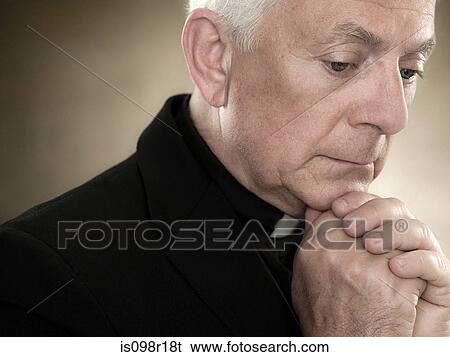 A priest praying View Large Photo Image Stock Photograph - A priest praying. Fotosearch