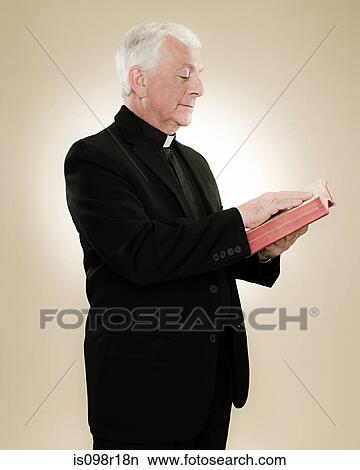 Picture - A priest reading a bible. Fotosearch