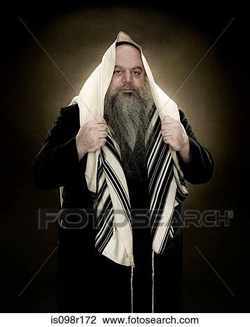 A rabbi wearing a prayer shawl View Large Photo Image Stock Image - A rabbi wearing a prayer shawl. Fotosearch