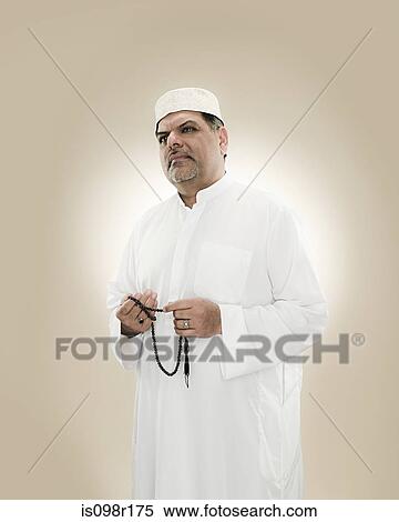 Portrait of a muslim man holding prayer beads View Large Photo Image Stock Photography - Portrait of a muslim man holding prayer beads. Fotosearch
