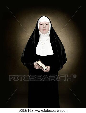 Portrait of a nun holding a bible View Large Photo Image Stock Photo - Portrait of a nun holding a bible. Fotosearch