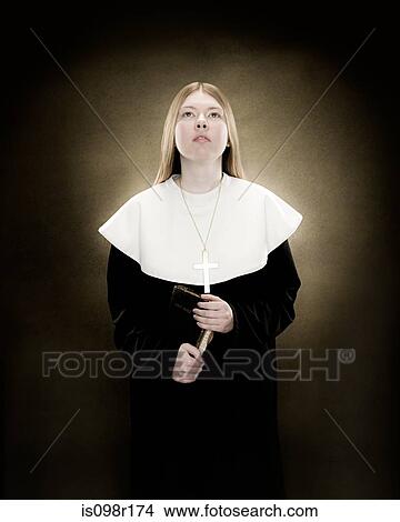 Portrait of a nun holding a prayer book View Large Photo Image Picture - Portrait of a nun holding a prayer book. Fotosearch