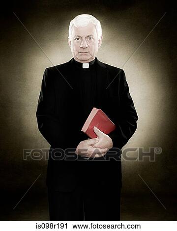 Portrait of a priest holding a bible View Large Photo Image Stock Image - Portrait of a priest holding a bible. Fotosearch