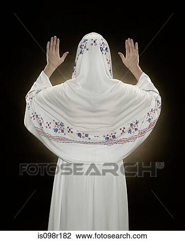 Rear view of a young muslim woman praying View Large Photo Image Stock Image - Rear view of a young muslim woman praying. Fotosearch