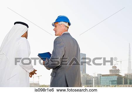 A businessman and an architect View Large Photo Image Stock Photograph - A businessman and an architect. Fotosearch