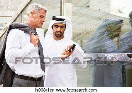 A businessman showing cell phone View Large Photo Image Stock Photography - A businessman showing cell phone. Fotosearch