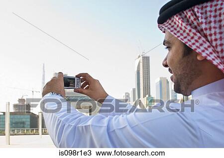 Stock Image - Businessman taking pictures. Fotosearch