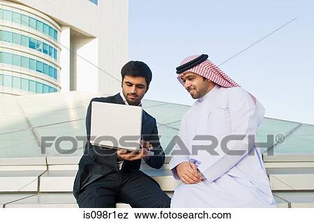Businessmen using a laptop View Large Photo Image Stock Photo - Businessmen using a laptop. Fotosearch