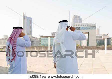 Businessmen using cell phones View Large Photo Image Stock Image - Businessmen using cell phones. Fotosearch