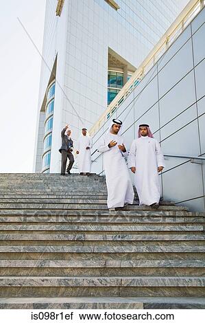 Businessmen walking down steps View Large Photo Image Stock Image - Businessmen walking down steps. Fotosearch