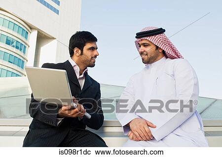Two businessmen talking View Large Photo Image Stock Image - Two businessmen talking. Fotosearch