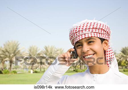 Stock Image - A boy using a cell phone. Fotosearch