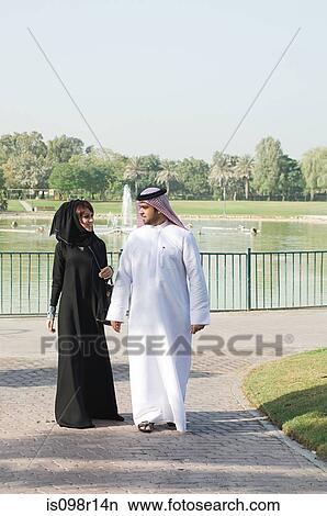 A couple walking in a park View Large Photo Image Picture - A couple walking in a park. Fotosearch
