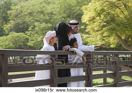Stock Photography - A family standing on a bridge. Fotosearch
