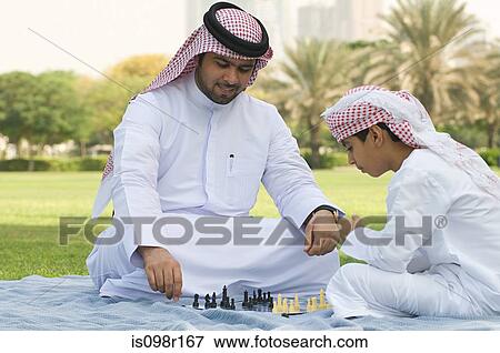 A father and son playing chess in a park View Large Photo Image Stock Photo - A father and son playing chess in a park. Fotosearch