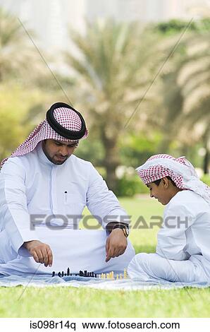 A father and son playing chess in a park View Large Photo Image Stock Photography - A father and son playing chess in a park. Fotosearch