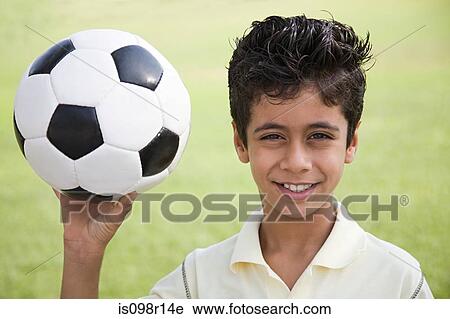 Portrait of a boy holding a football View Large Photo Image Stock Image - Portrait of a boy holding a football. Fotosearch
