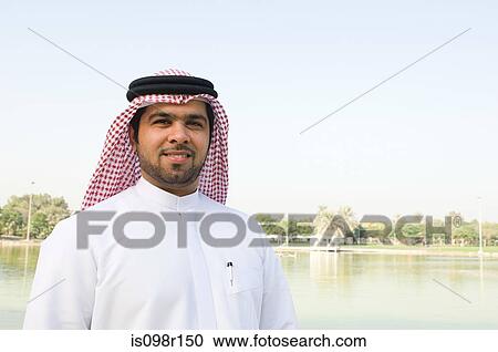 Stock Image - Portrait of a young man wearing a gutra. Fotosearch