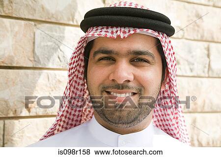 Portrait of a young man wearing a gutra View Large Photo Image Stock Photo - Portrait of a young man wearing a gutra. Fotosearch