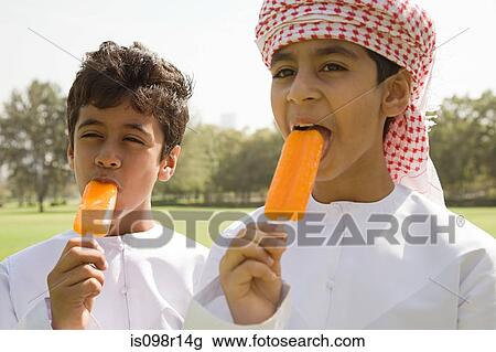Stock Image - Two boys having ice lollies. Fotosearch