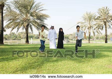 Two boys running in a park View Large Photo Image Stock Photograph - Two boys running in a park. Fotosearch