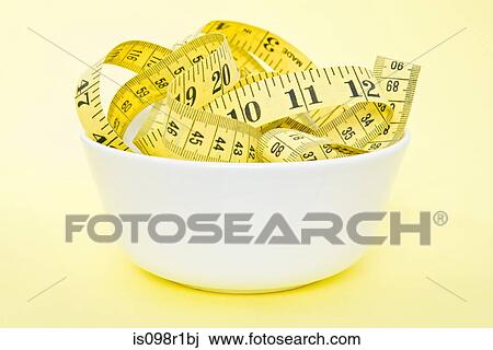 Stock Image - A tape measure in a bowl. Fotosearch