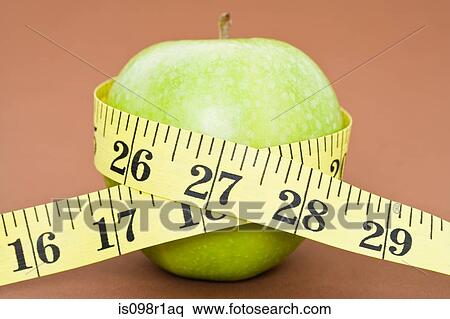 A tape measure wrapped around an apple View Large Photo Image Stock Photography - A tape measure wrapped around an apple. Fotosearch