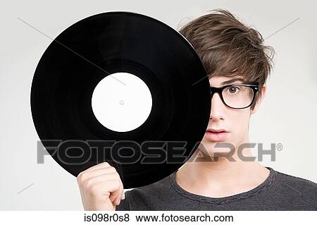 A teenage boy holding a vinyl record View Large Photo Image Stock Photo - A teenage boy holding a vinyl record. Fotosearch
