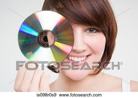 A teenage girl holding a cd View Large Photo Image Stock Photo - A teenage girl holding a cd. Fotosearch