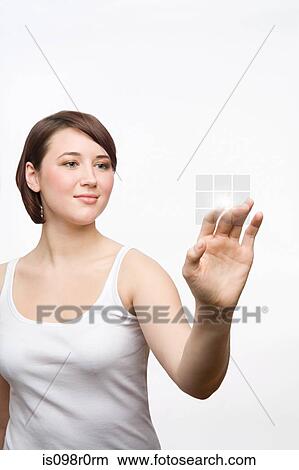 A teenage girl pressing push buttons View Large Photo Image Picture - A teenage girl pressing push buttons. Fotosearch