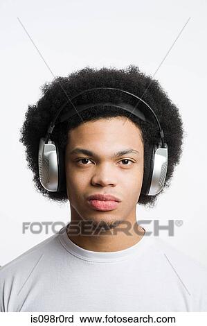 A young man listening to music View Large Photo Image Stock Image - A young man listening to music. Fotosearch