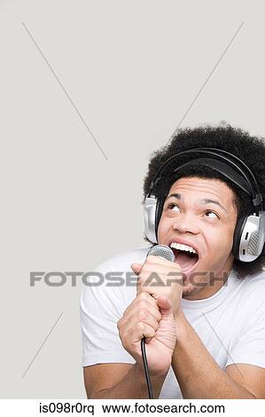 Stock Photography - A young man singing. Fotosearch