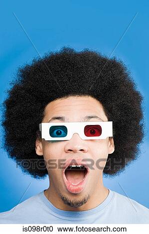 A young man wearing 3d glasses View Large Photo Image Stock Image - A young man wearing 3d glasses. Fotosearch
