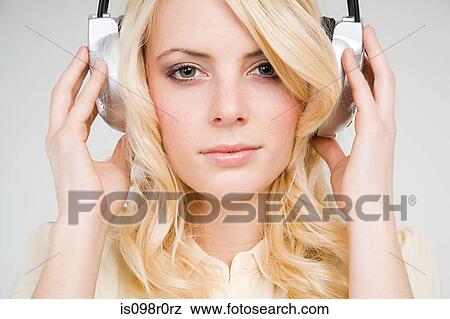 Stock Photo - A young woman listening to music. Fotosearch