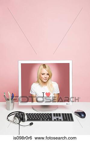 A young woman on a computer View Large Photo Image Stock Photograph - A young woman on a computer. Fotosearch