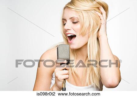 Stock Image - A young woman singing. Fotosearch