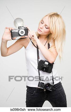 A young woman taking pictures View Large Photo Image Stock Image - A young woman taking pictures. Fotosearch