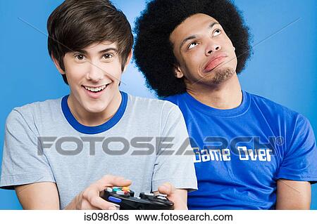 Friends playing a video game View Large Photo Image Stock Photograph - Friends playing a video game. Fotosearch