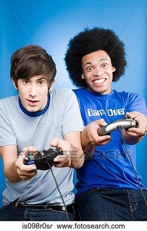Friends playing a video game View Large Photo Image Stock Photography - Friends playing a video game. Fotosearch