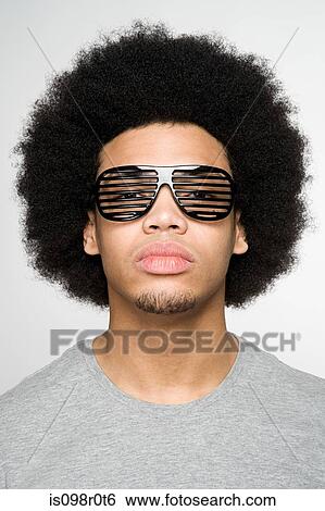 Portrait of a young man wearing sunglasses View Large Photo Image Stock Photograph - Portrait of a young man wearing sunglasses. Fotosearch