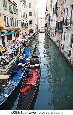 A restaurant and gondolas on a canal in venice View Large Photo Image Stock Image - A restaurant and gondolas on a canal in venice. Fotosearch