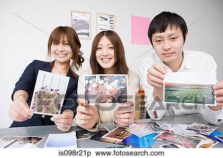 People holding photographs View Large Photo Image Stock Photography - People holding photographs. Fotosearch