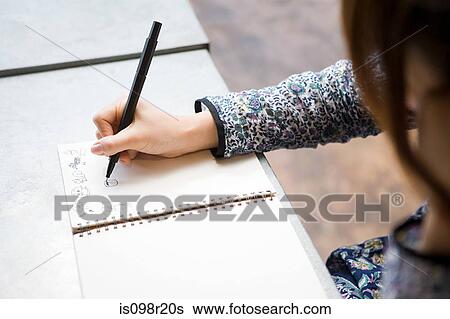 Woman drawing in notebook View Large Photo Image Stock Photograph - Woman drawing in notebook. Fotosearch