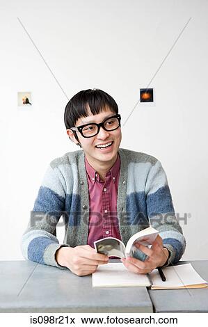Young man with book View Large Photo Image Stock Photo - Young man with book. Fotosearch